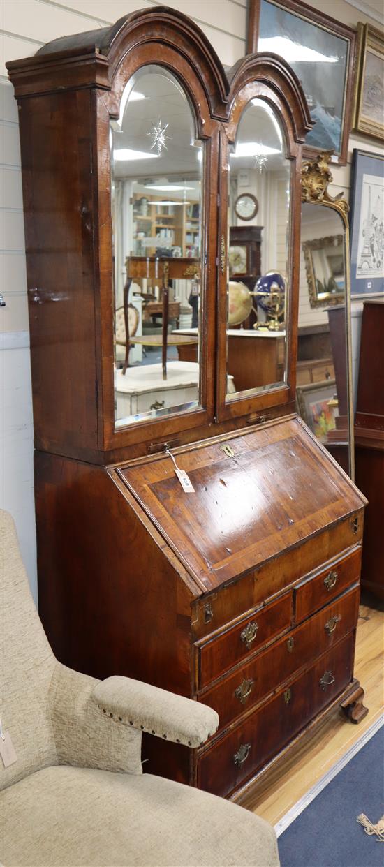 A George I featherbanded walnut bureau bookcase, W.3ft 4in. D.1ft 10in. H.7ft